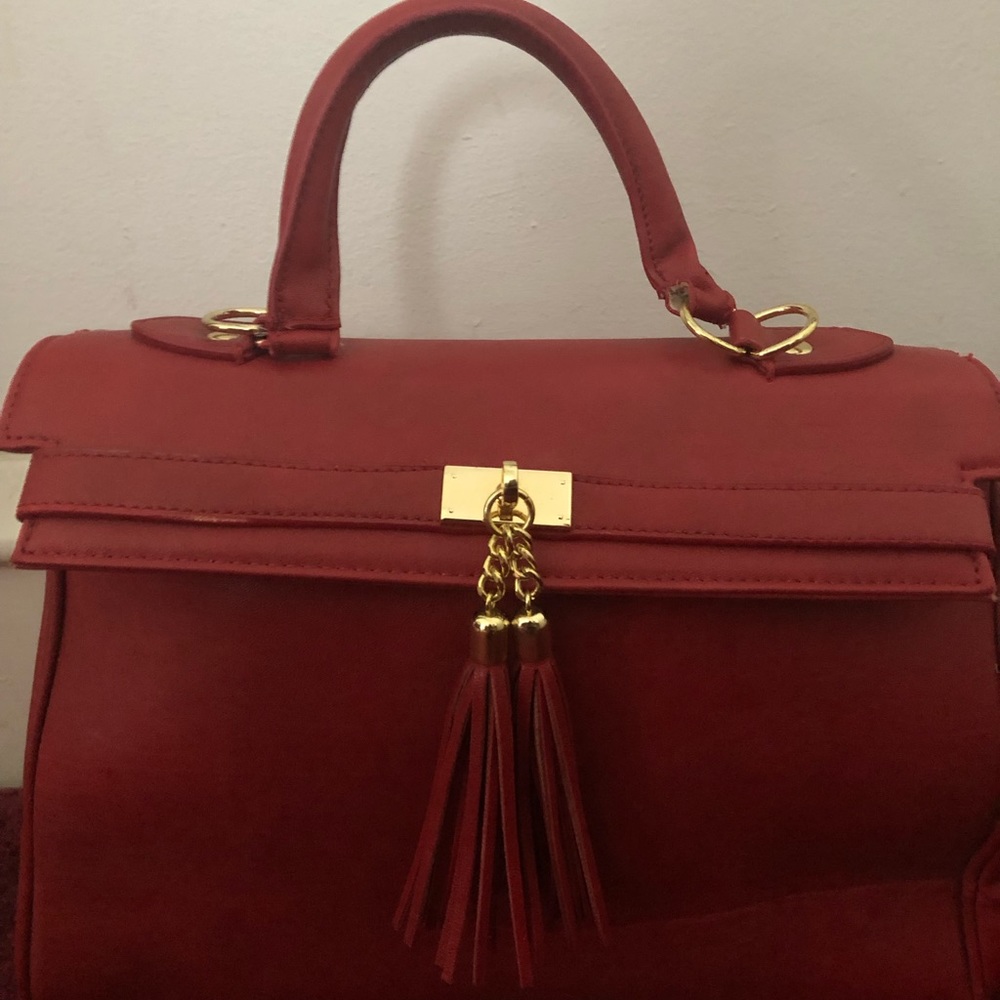 Aldo red leather purse with tassel.